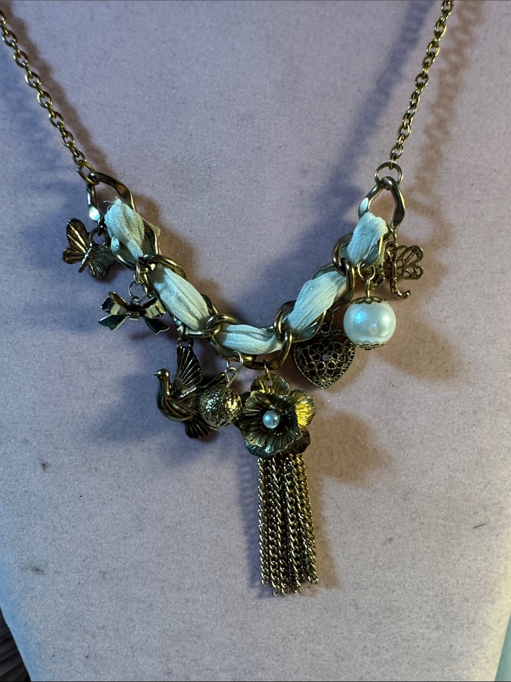 Gold-Tone Charm Tassel Necklace with Ivory Ribbon Accent 14”